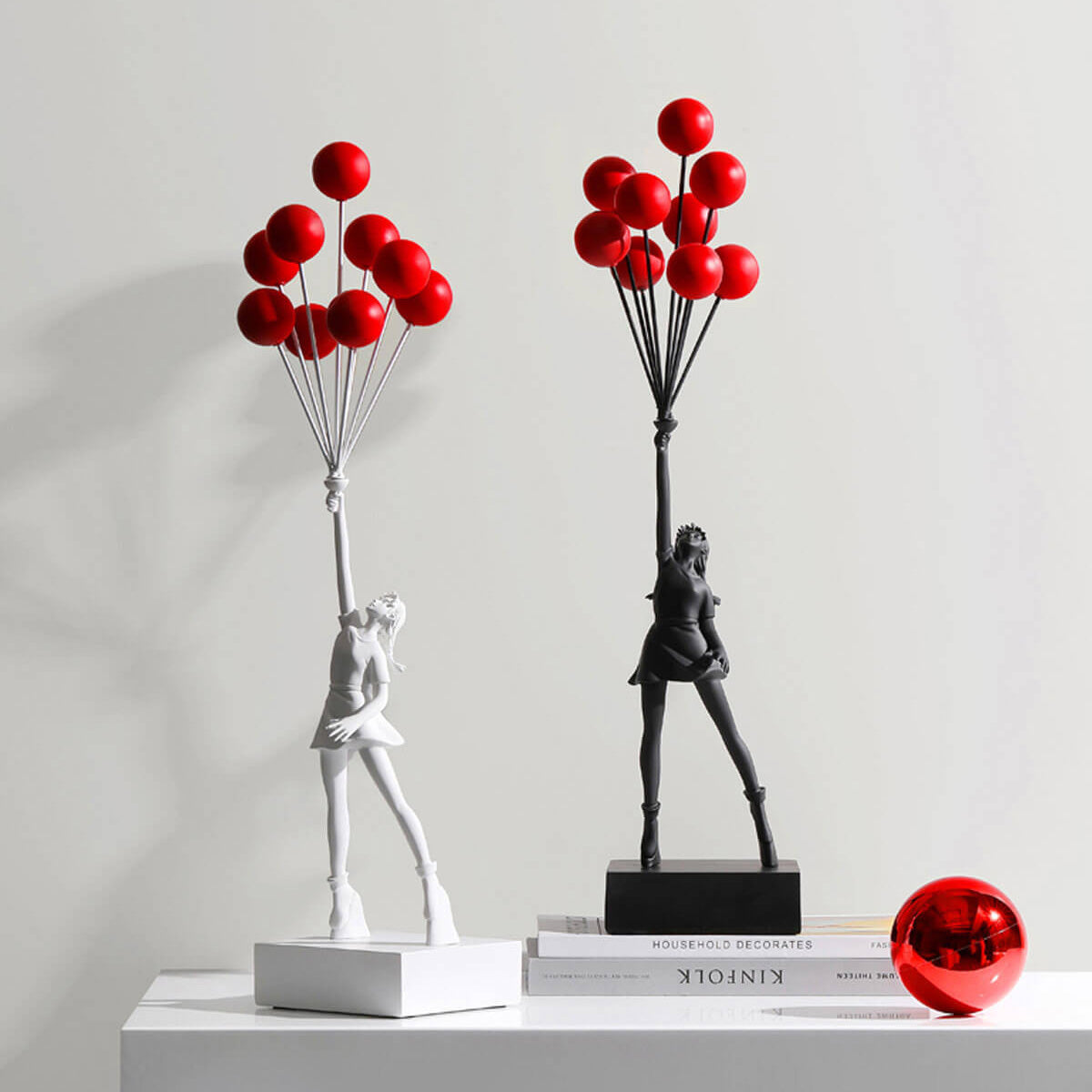 Flying Balloon Girl Banksy Statue in black and white with red balloons, modern urban art decor